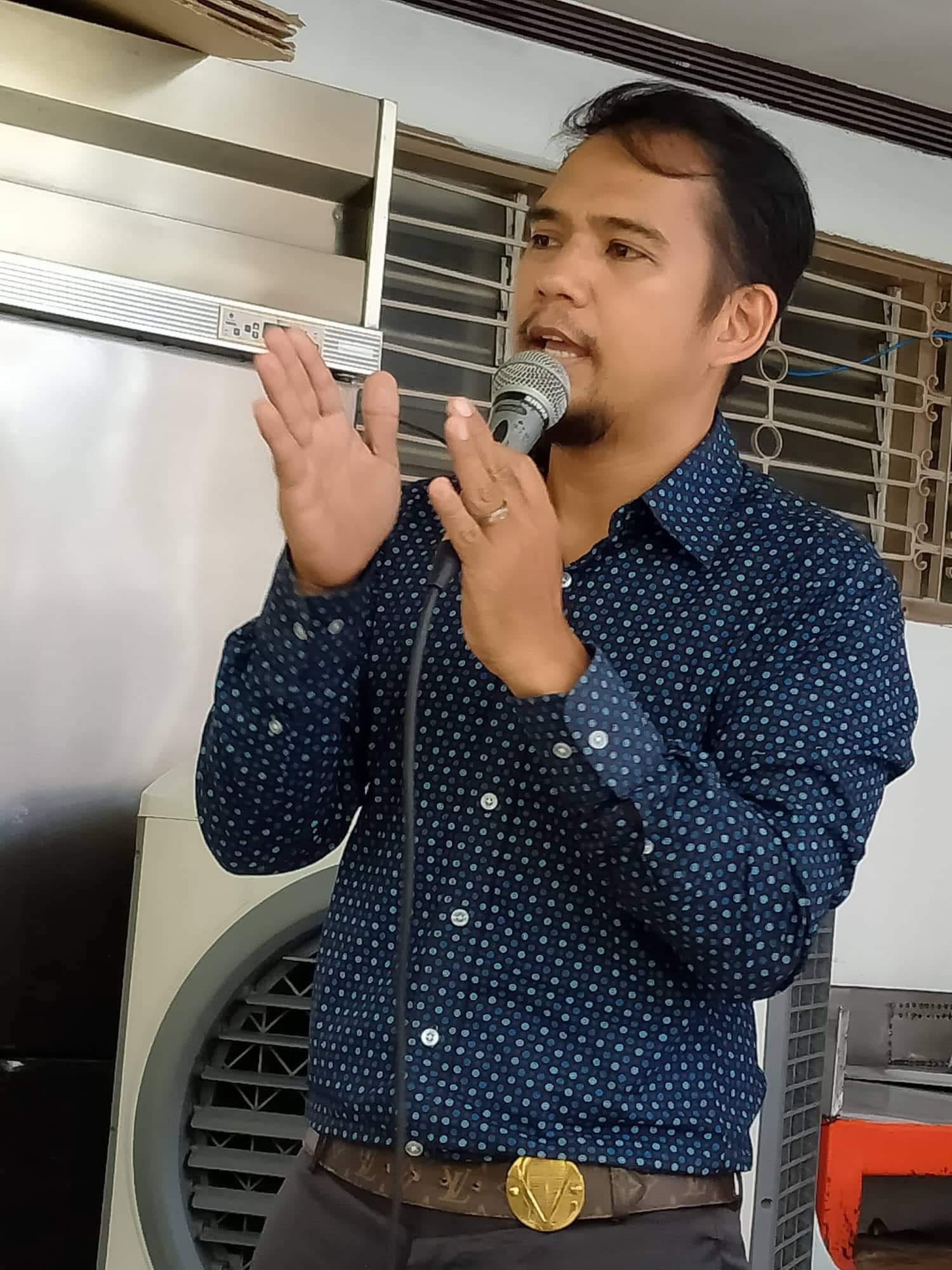 Pastor Jireh preaching with a microphone during an early Gateway Impact Church gathering